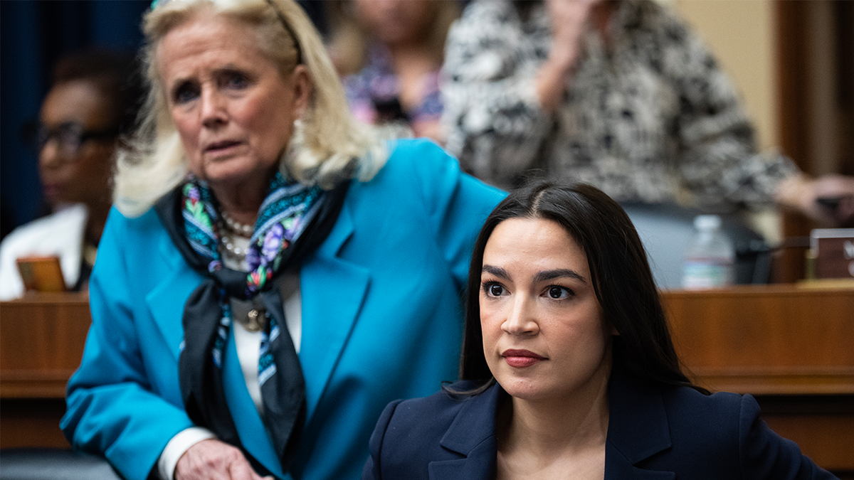 AOC, sitting with Deby Dengel to her right