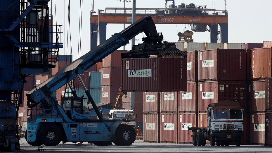 A mobile crane carrying a container