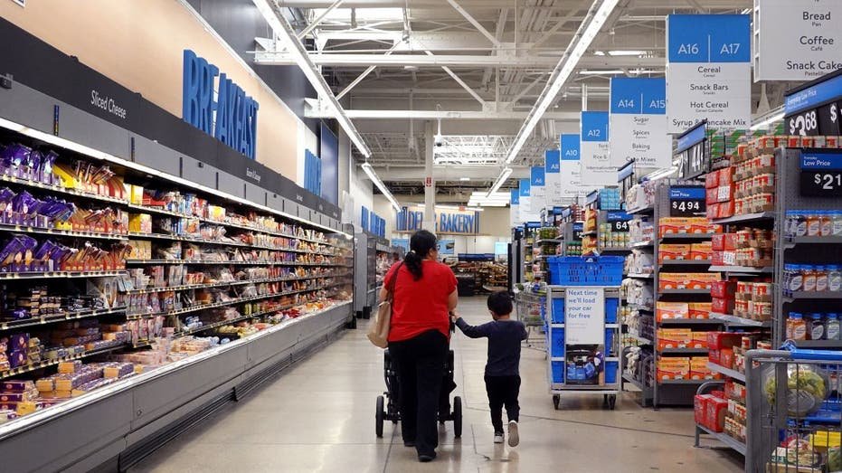 A woman and a child walking in Wall Mart