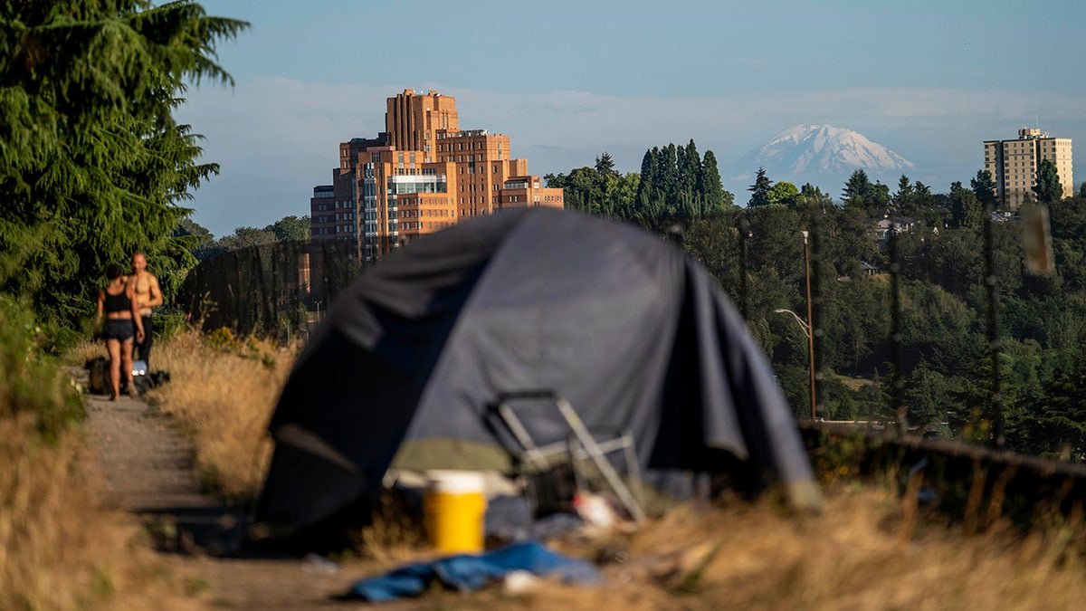The tent sits alongside I-5 near Seattle with the city in the background