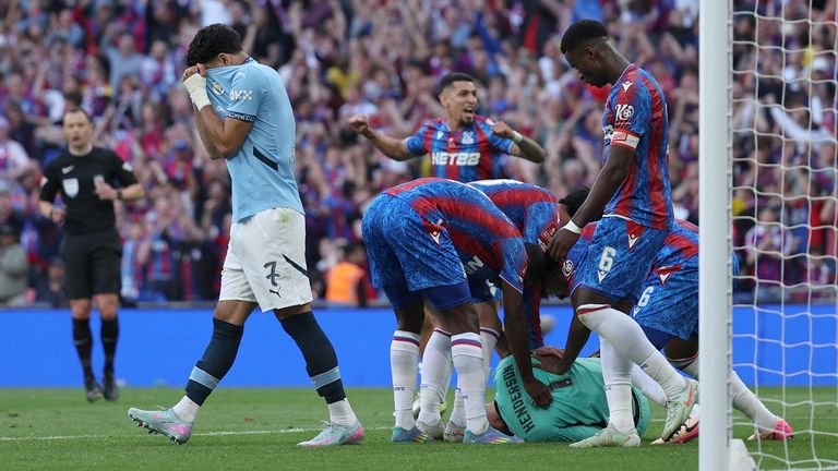 Brigadier Henderson was mobilized by his teammates after saving Omar Marmoush's penalty