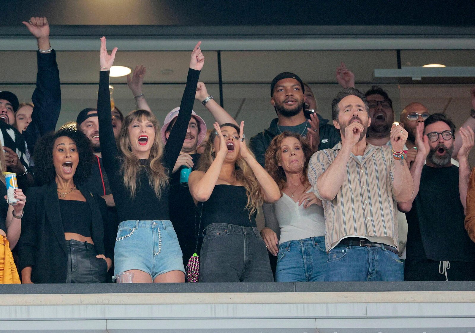 Singer Taylor Swift with actors Blake Livley, Ryan Reynolds, and Hue Jackman in Jets Chief Game