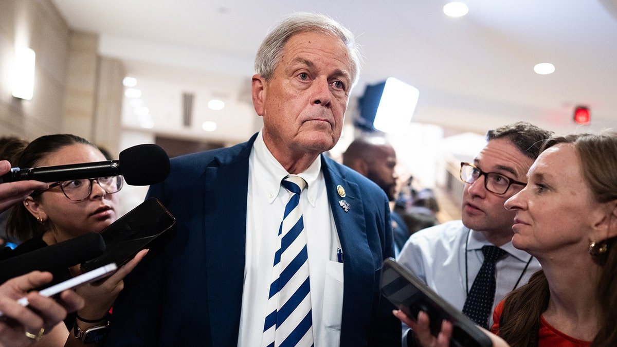 Norman is surrounded by journalists 