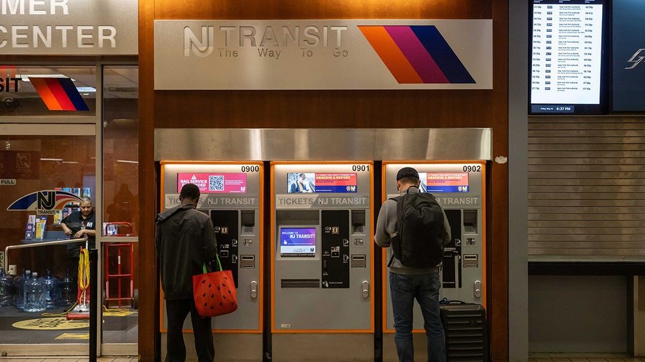 People stand in the nj transit ticket booth