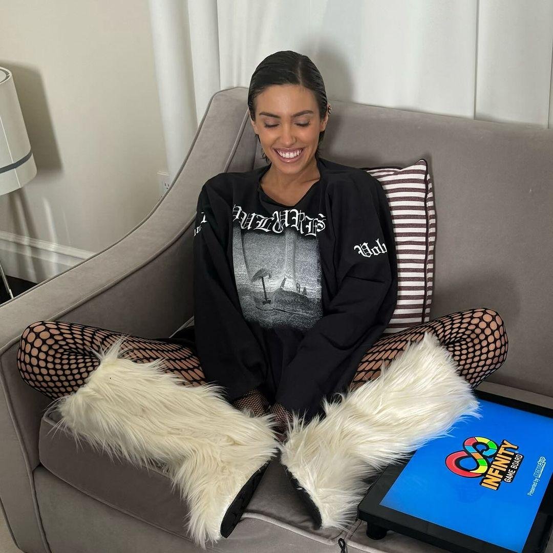 Kanye West Bianca Siaraori's wife smiles with her eyes closed on the sofa