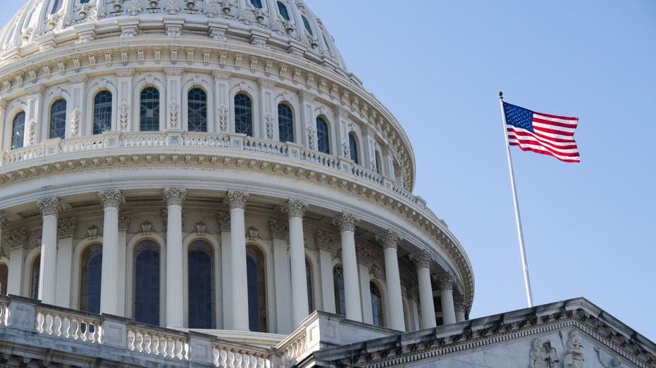The American flag flies over the American Capitol