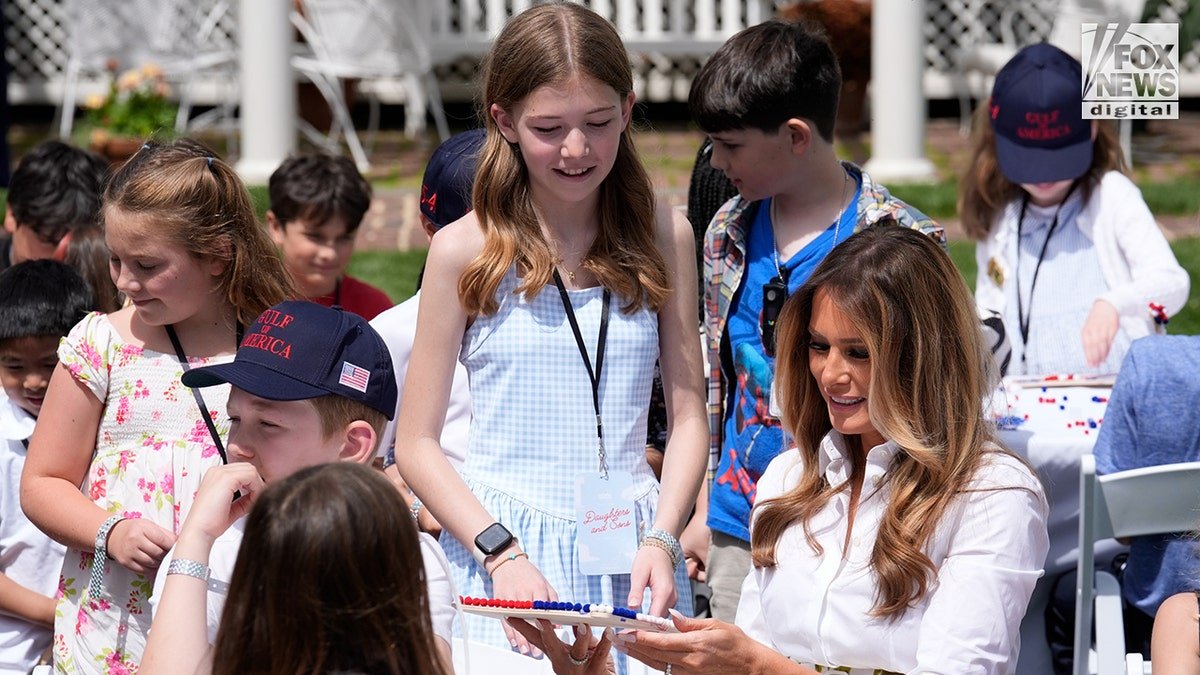Flotus sits with children in the White House garden.