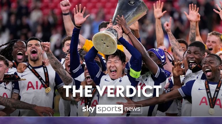 Tottenham's son, Hyung Min, holds the cup high as he celebrates with his teammates after winning the final <a href=