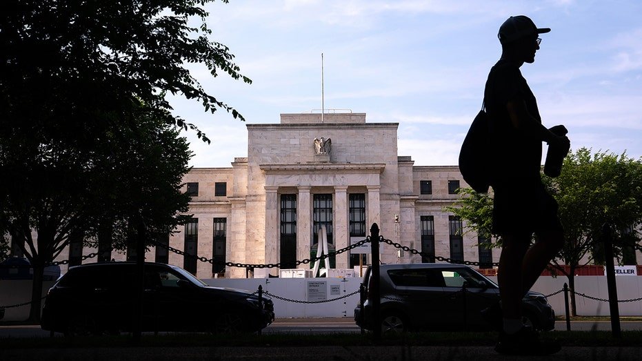 Federal Reserve Building in Washington, DC with a person walking in the past