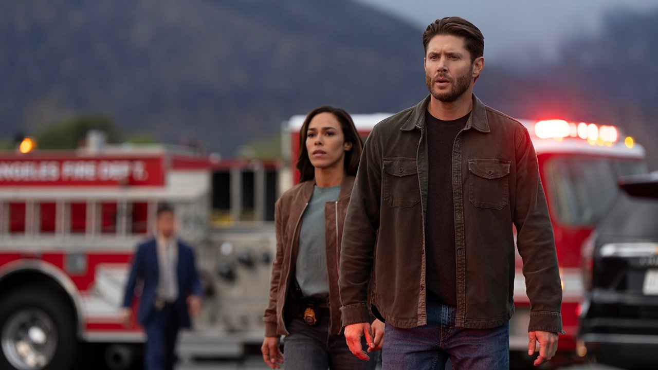 Jensen Ackles walks with a woman, Firetrucks in the background in the countdown.