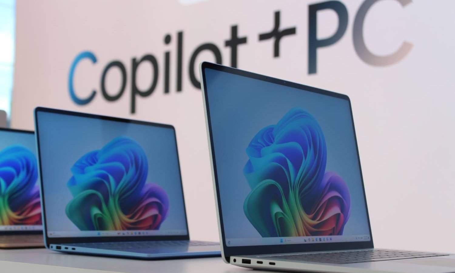 The surface laptop appears in front of the Copilot+sign.