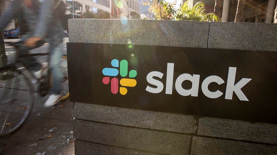 Slack on Sign and a motorcycle passenger passes it