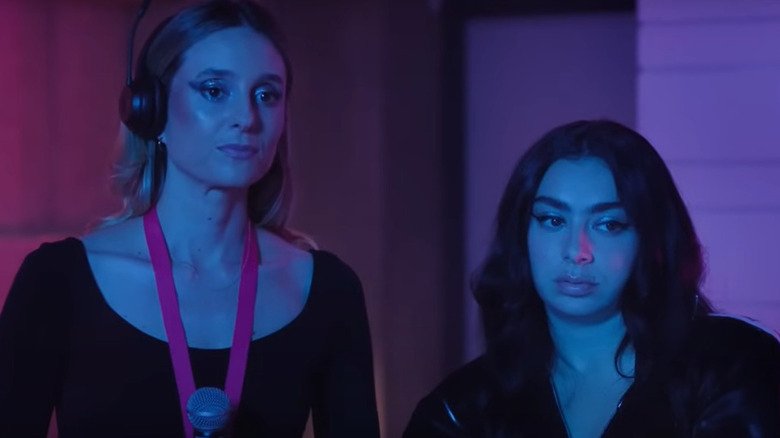 Grace and Charli XCX stand side by side in excessive compensation