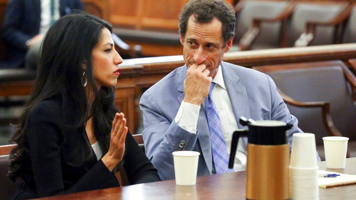 Anthony Winner, right, are installed in court in New York on Wednesday, September 13, 2017. The couple asked the New York City judge in the divorce case. (Jefferson Siegel/The Daily News via AP, swimming pool)