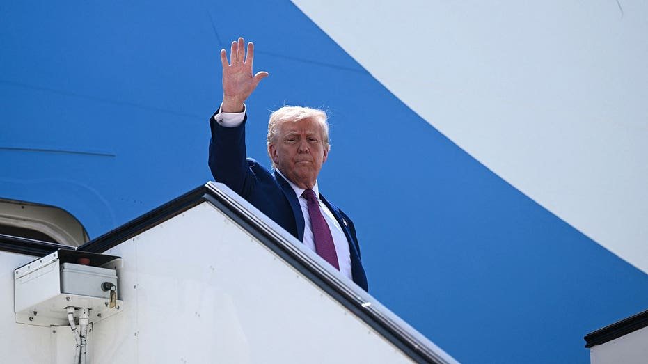 Topshot - US President Donald Trump waving goodbye as he flying the first air force at his next stop, at the end of the Qatari leg on his regional tour at the southwestern air base from Doha on May 15, 2025.
