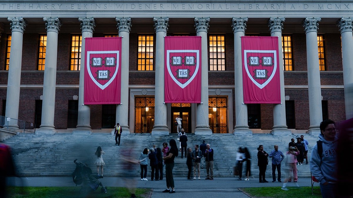 Harvard University banners are hanging from the building