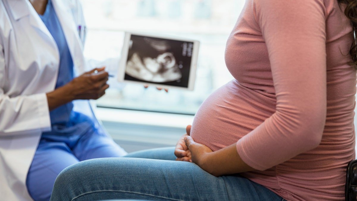 A pregnant woman in the doctor
