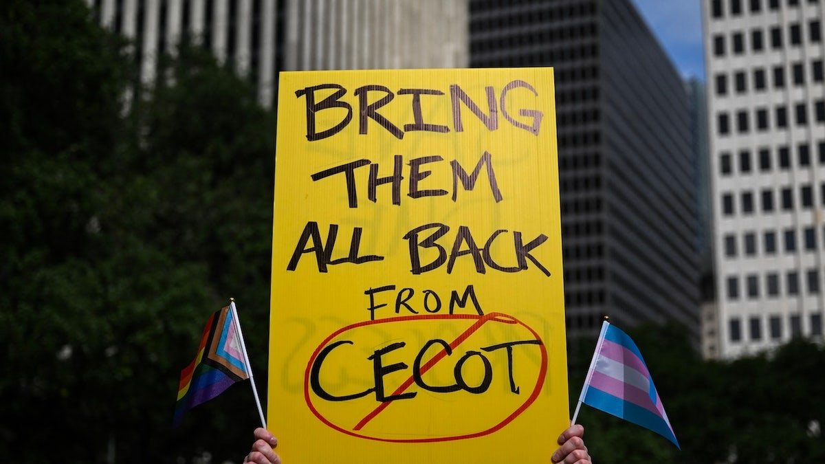 The person holds a sign indicating the center of terrorism in El Salvador during a demonstration on May against President Donald Trump and immigration policies in Houston on May 1, 2025.