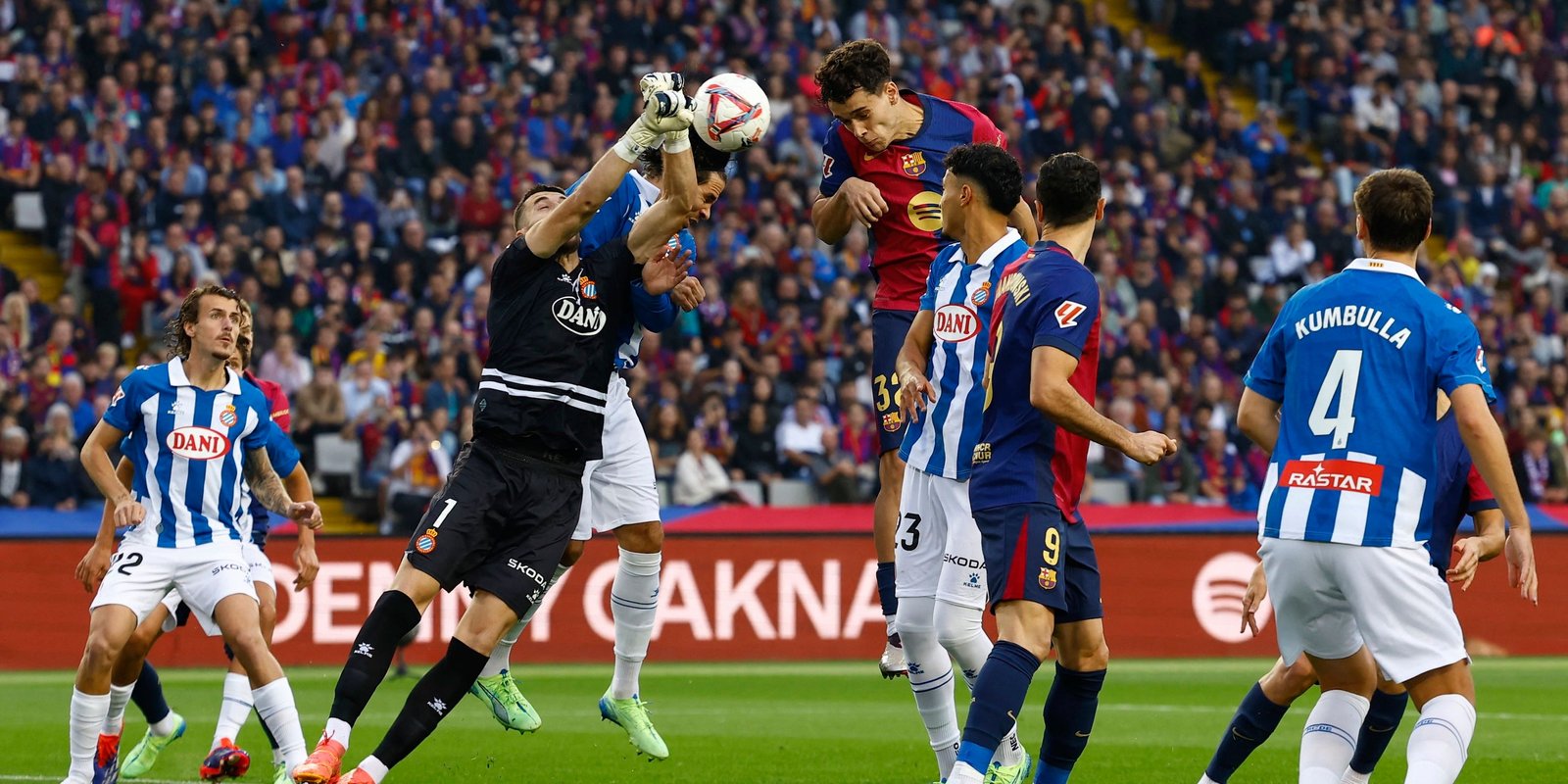 RCD Espanyol's Joan Garcia at work with FC Barcelona's Hector Fort