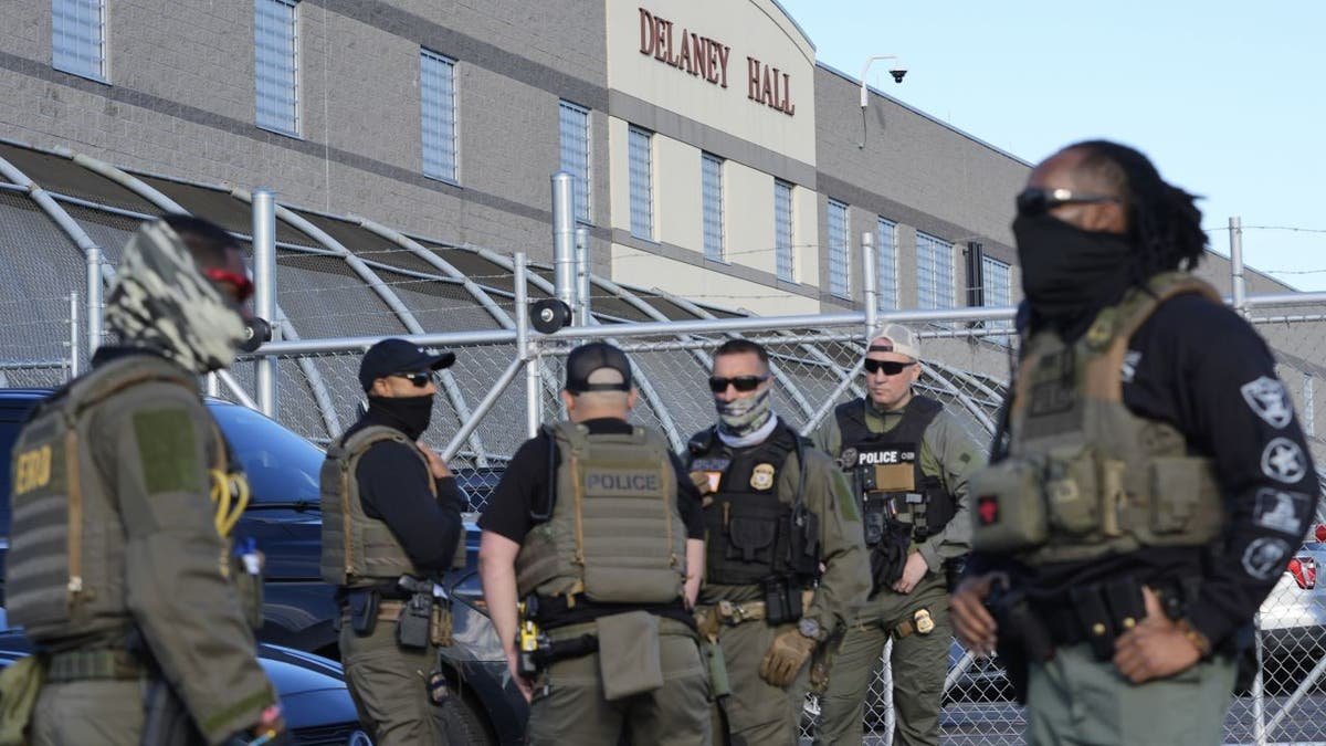 Security personnel stand in front of Delaney Hall, a recent reopened migration center, in Newark, New Jersey, on Wednesday, May 7, 2025 (AP Photo/Seth Wenig)