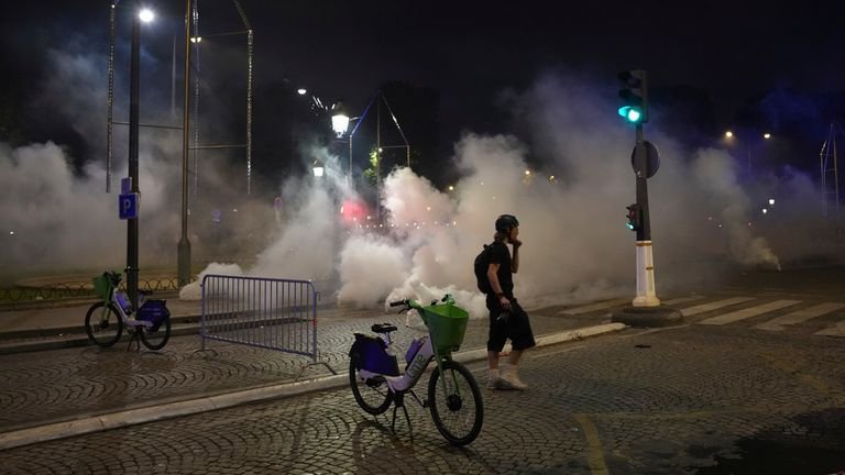 A man walking in tear gas during accidents after the Champions League final