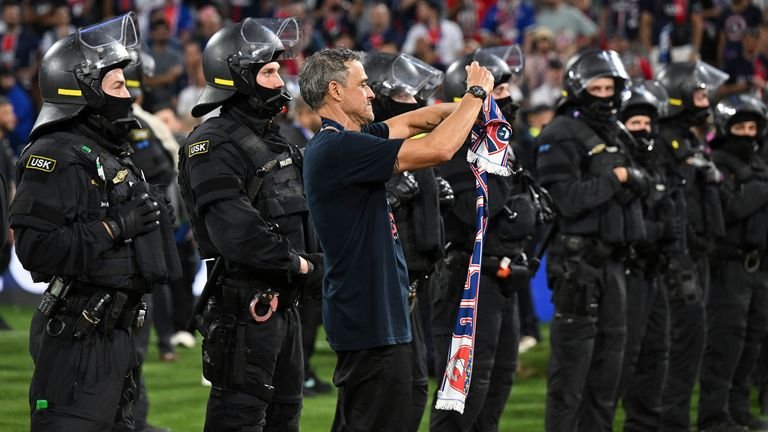 Luis Enrique celebrates PSG fans in the riot police