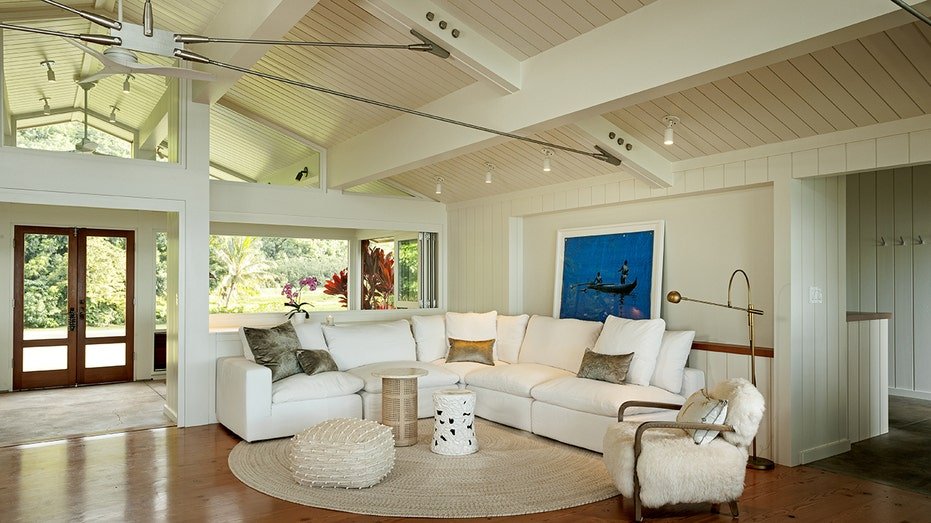 The living room features a cathedral ceiling with wooden panels.
