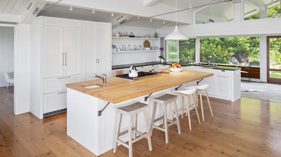 The kitchen has a large island to eat in a center.