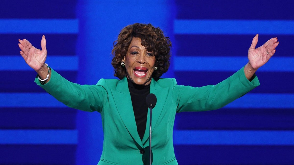 American gestures Maxine Waters (D-CA) at the United Nations, on the first day of the Democratic National Congress