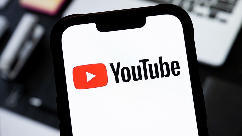 YouTube logo on the phone screen