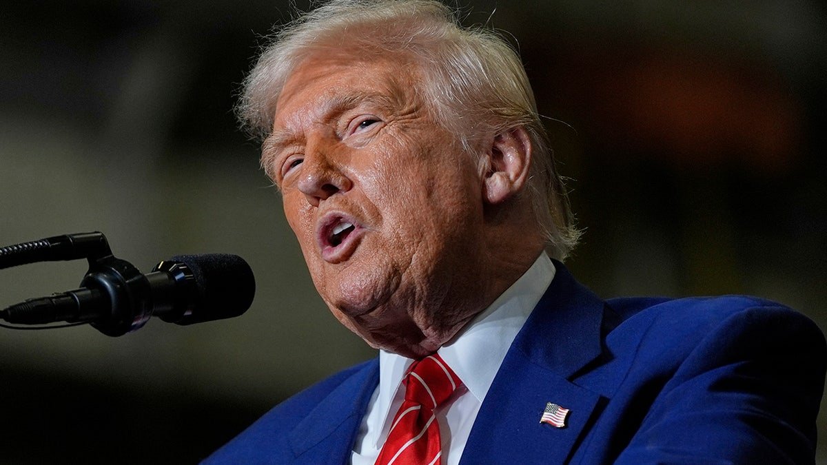 President Donald Trump in the red tie speaks