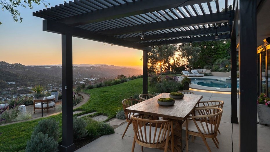 The hill over the hill overlooking the mountains is found in the backyard.