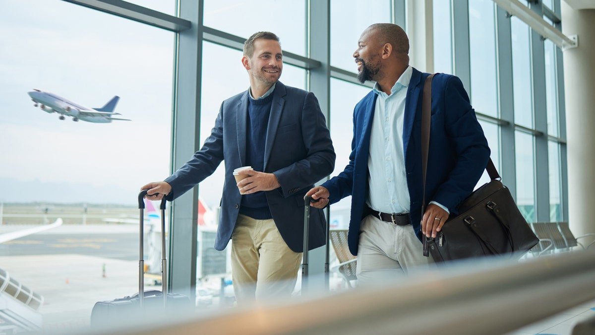 Businessmen walk at the airport