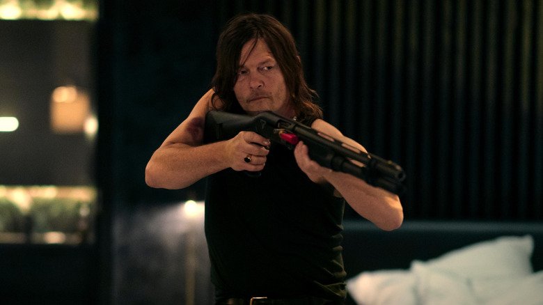 Norman Redos in the role of Daniel holds his rifle in his room in his hotel from the world of John Wake: a ballet dancer