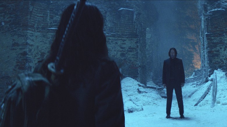 John Wake faces Eve with her back to the camera and a sword on her back