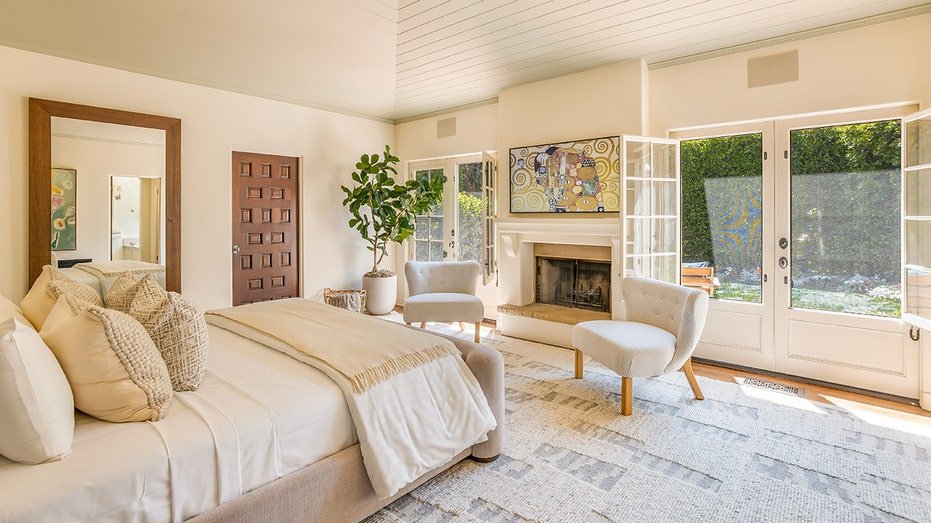 The basic bedroom features a fireplace located on firewood and access to yard.