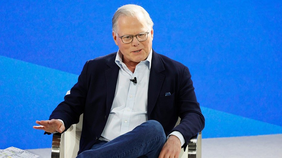 David Zasslav sits while speaking at an event