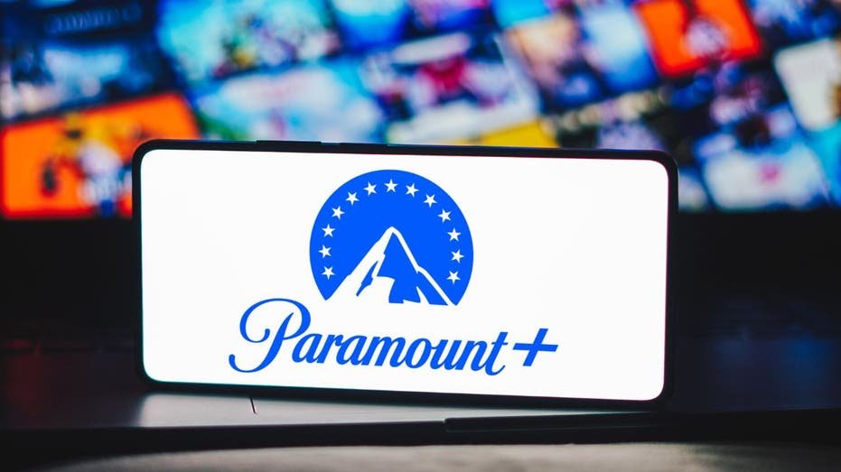 The Paramount Plus logo is displayed on the smartphone screen.