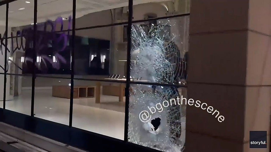 A huge hole in a glass window from the Apple store