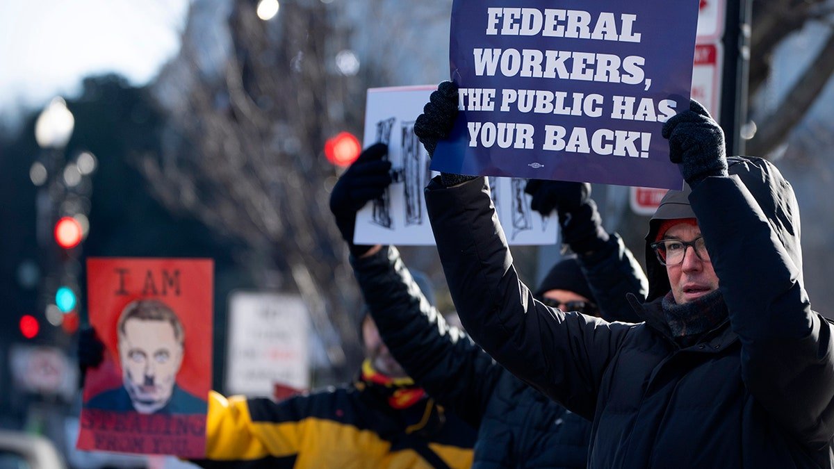 Protesters with signs protesting HHS discounts