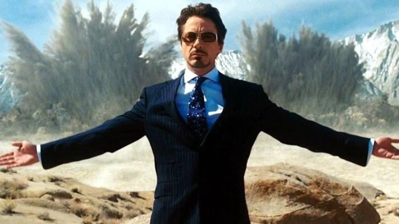 Robert Downey Junior Tony Stark with explosions behind him in the iron man