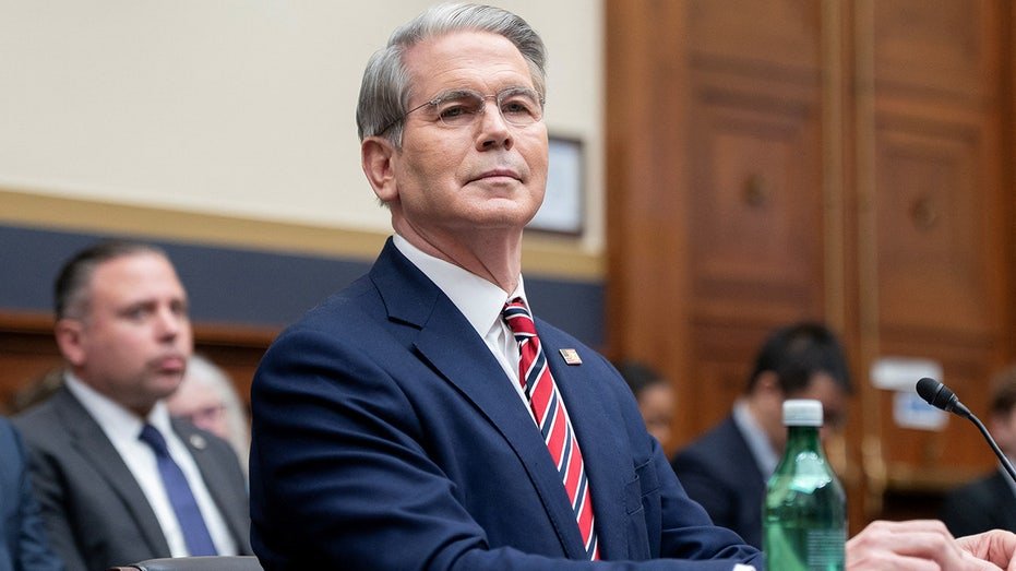 Treasury Secretary Scott Besent wears a red tie and a dark suit, as he witnesses in a home hearing