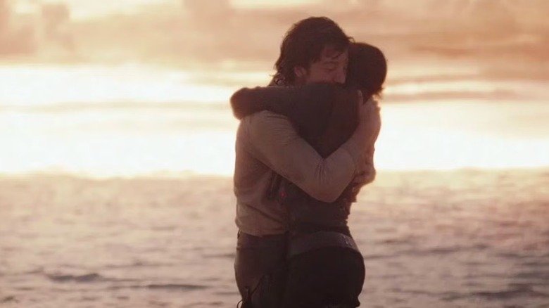 Jane Eerso and Cassian Anwar carry each other while the star of death explodes in the rogue