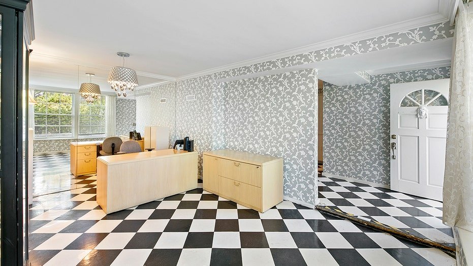The property also includes a possible guesthouse with black and white floors.