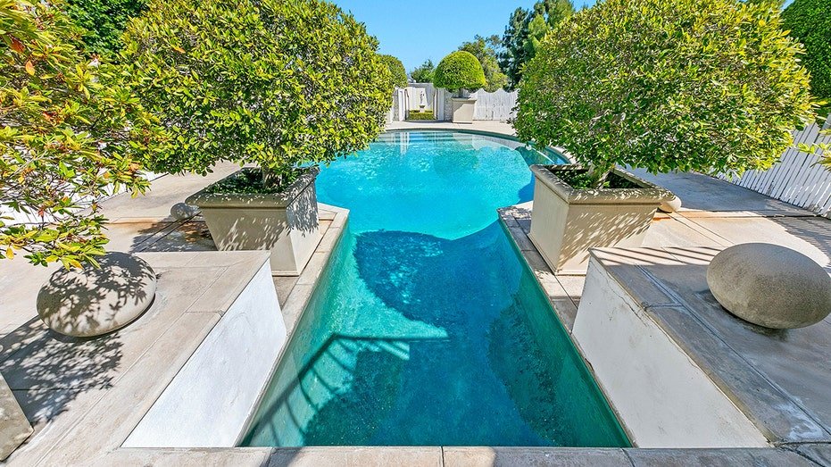 The backyard is characterized by a unique swimming.