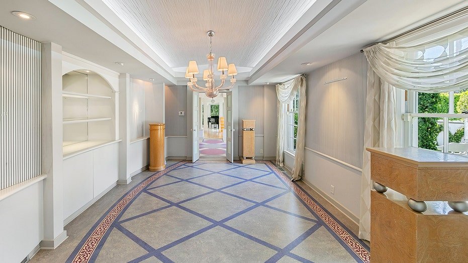 The dining room features custom floors and blue and white striped walls.
