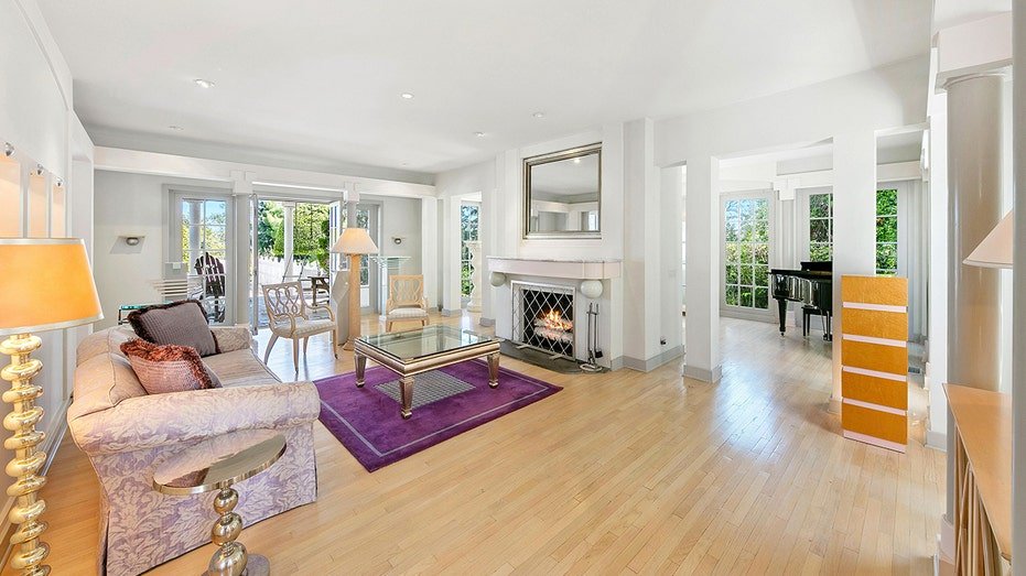 The living room features a fireplace located on firewood and reaching the backyard.