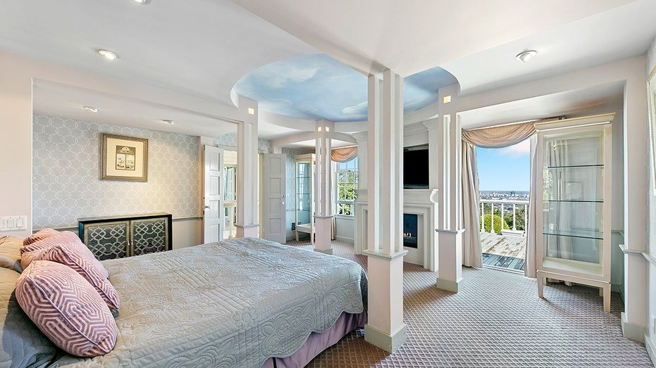 The primary bedroom features a wood burning fireplace and access to an outdoor balcony.