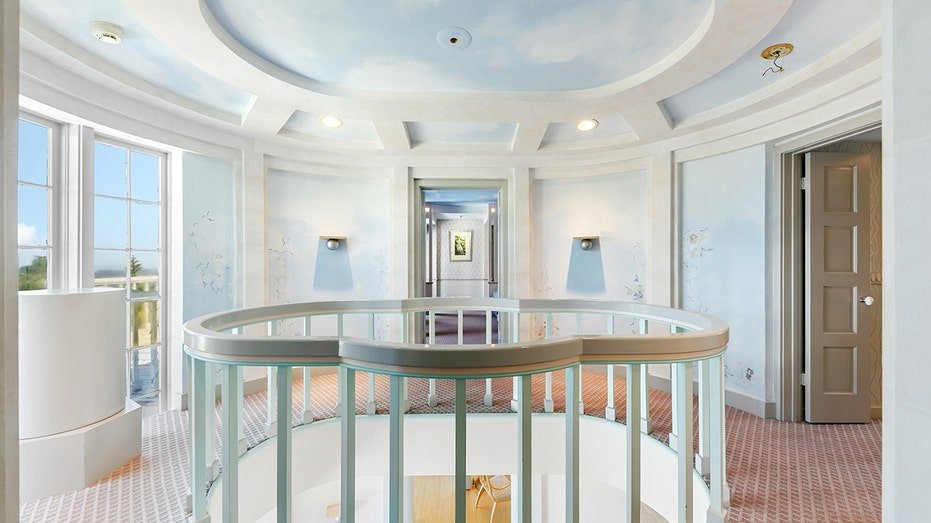 The stairs lead to the upper floor where the ceilings and walls were drawn to look like the sky.