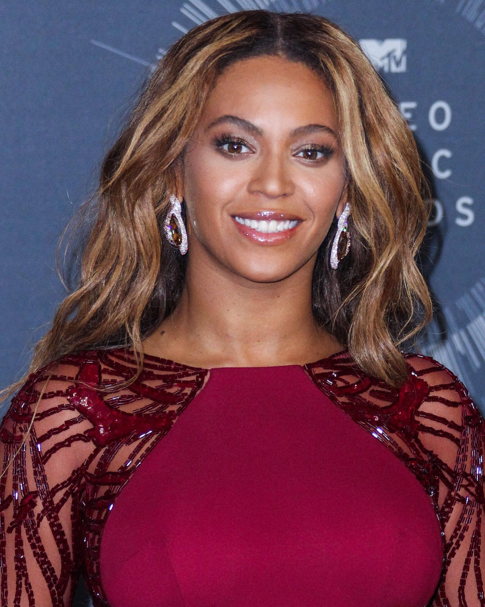 Beyonce wears the maroon dress